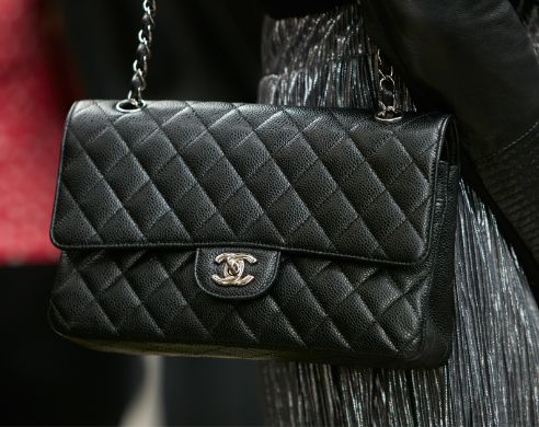 Woman with black Chanel leather bag