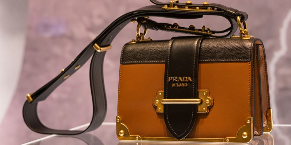 Close Up Of A Prada Handbag On An Acrylic Stand