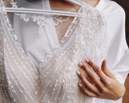 close up of a bride holding her wedding dress
