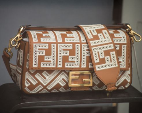 Closeup of brown leather handbag by Fendi in a luxury fashion store showroom