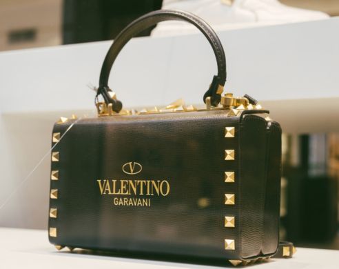 Valentino leather pouch with logotype of Valentino Garavani with golden letters and ornaments