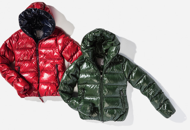 Two Glossy Puffer Jackets With Hoods, One Red And One Dark Green, Displayed Side By Side On A White Background, Embodying Couture Excellence. Perfect For Any Wardrobe Care Enthusiast Seeking To Blend Fashion With Functionality.