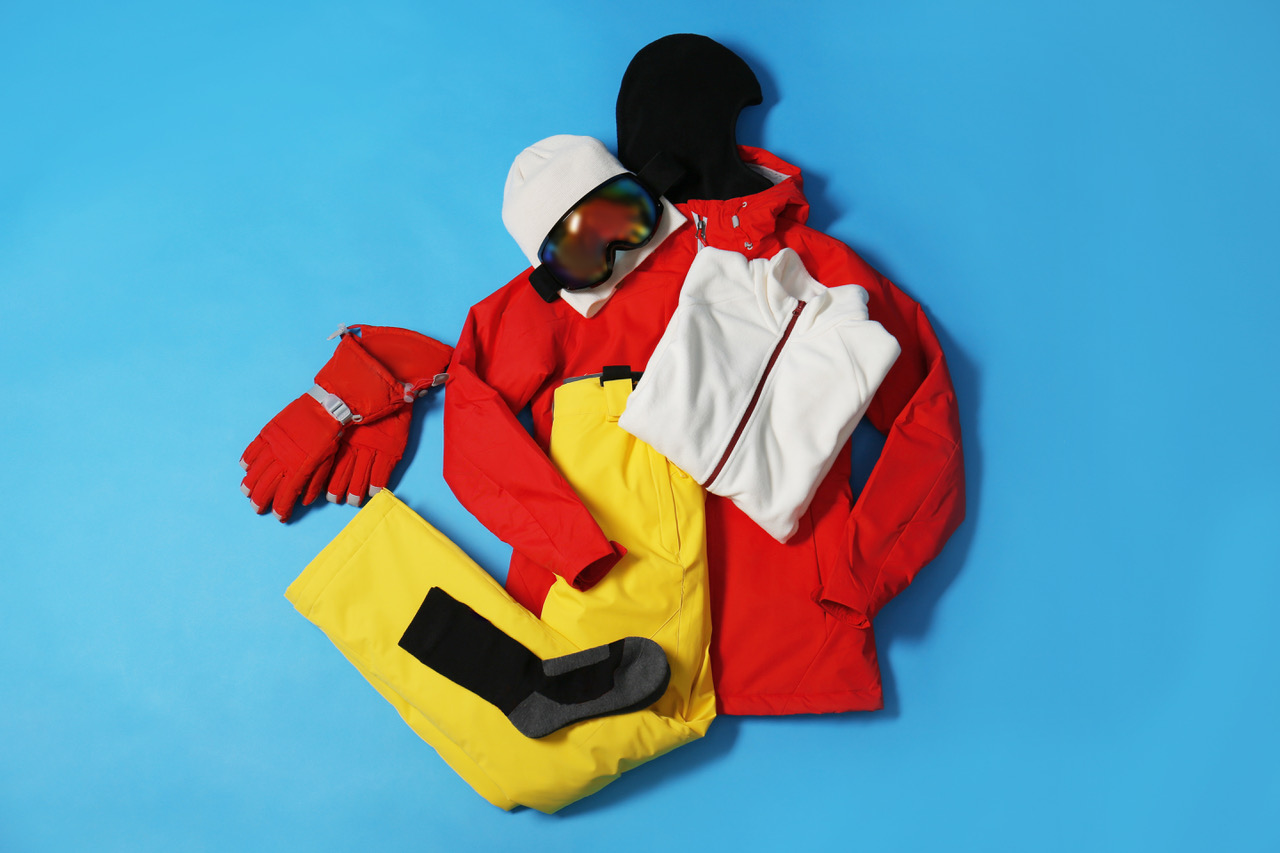 Pile of ski clothes on a blue background