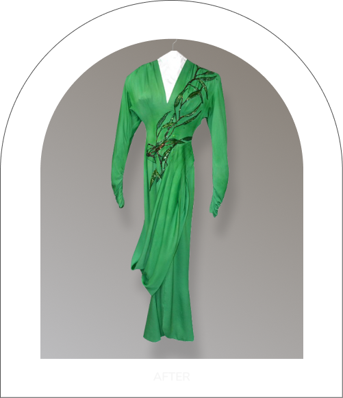 Green long-sleeved draped dress with black embroidered details