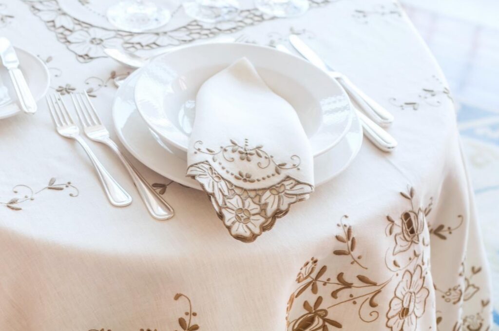 Embroidered cutwork tablecloth and napkin cleaned and pressed by Margaret’s