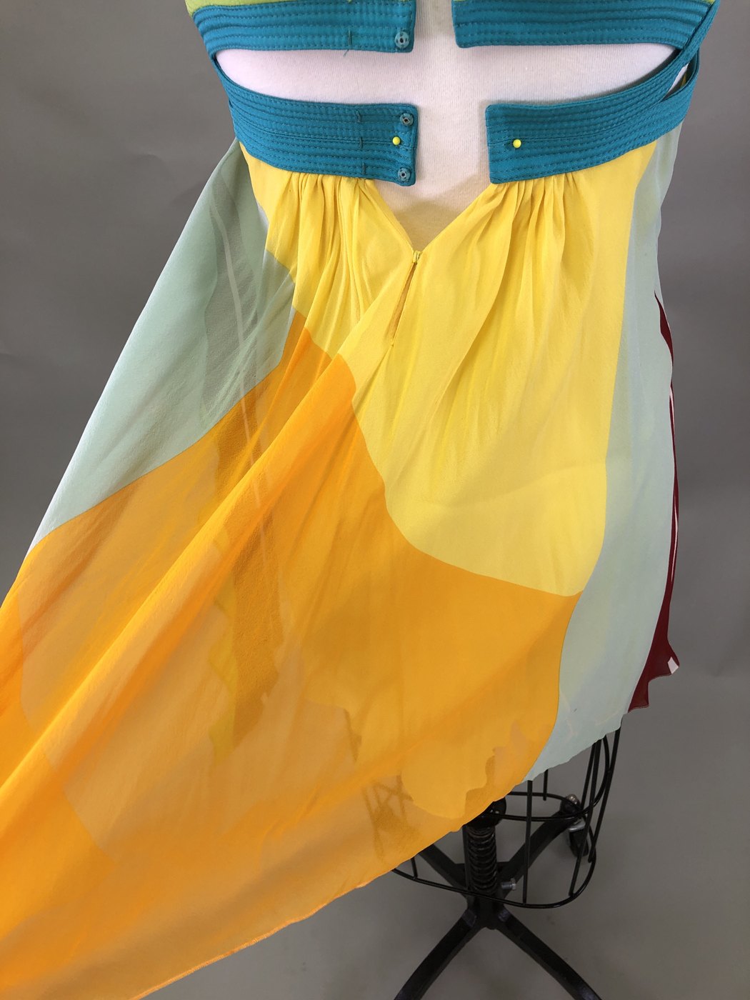 Before cleaning: the Versace dress's gathered color-block skirt on a dress form, showing soil and creasing